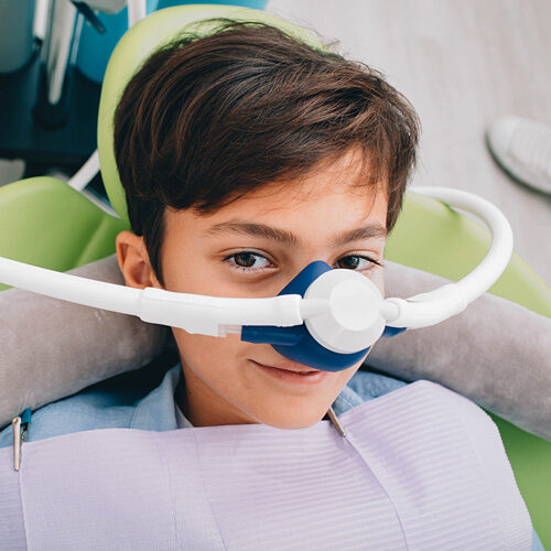 Boy Getting Inhalation Sedation During Dental Treatment