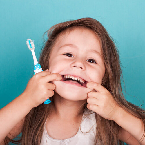 Little Girl showing teeth after dental exams