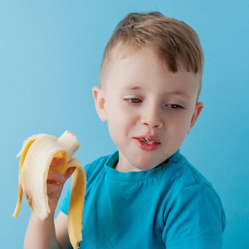 Little Boy Eating a Healthy Banana